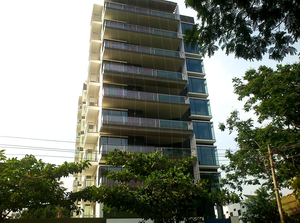 High-rise residential tower with glass balconies in Coimbatore